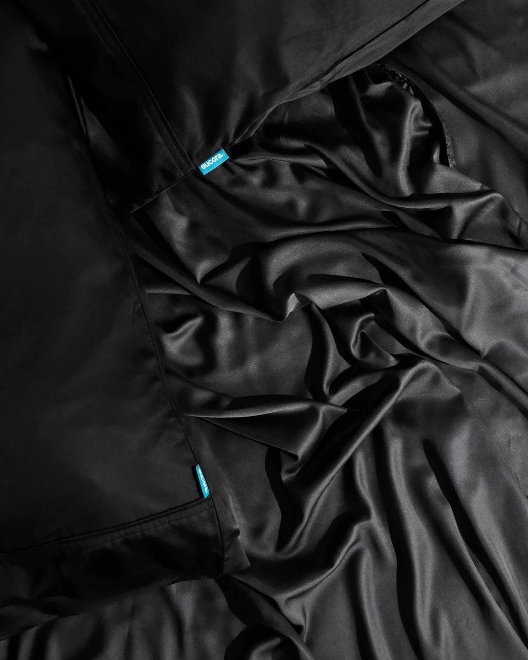 Close-up of black fabric with a brand label.