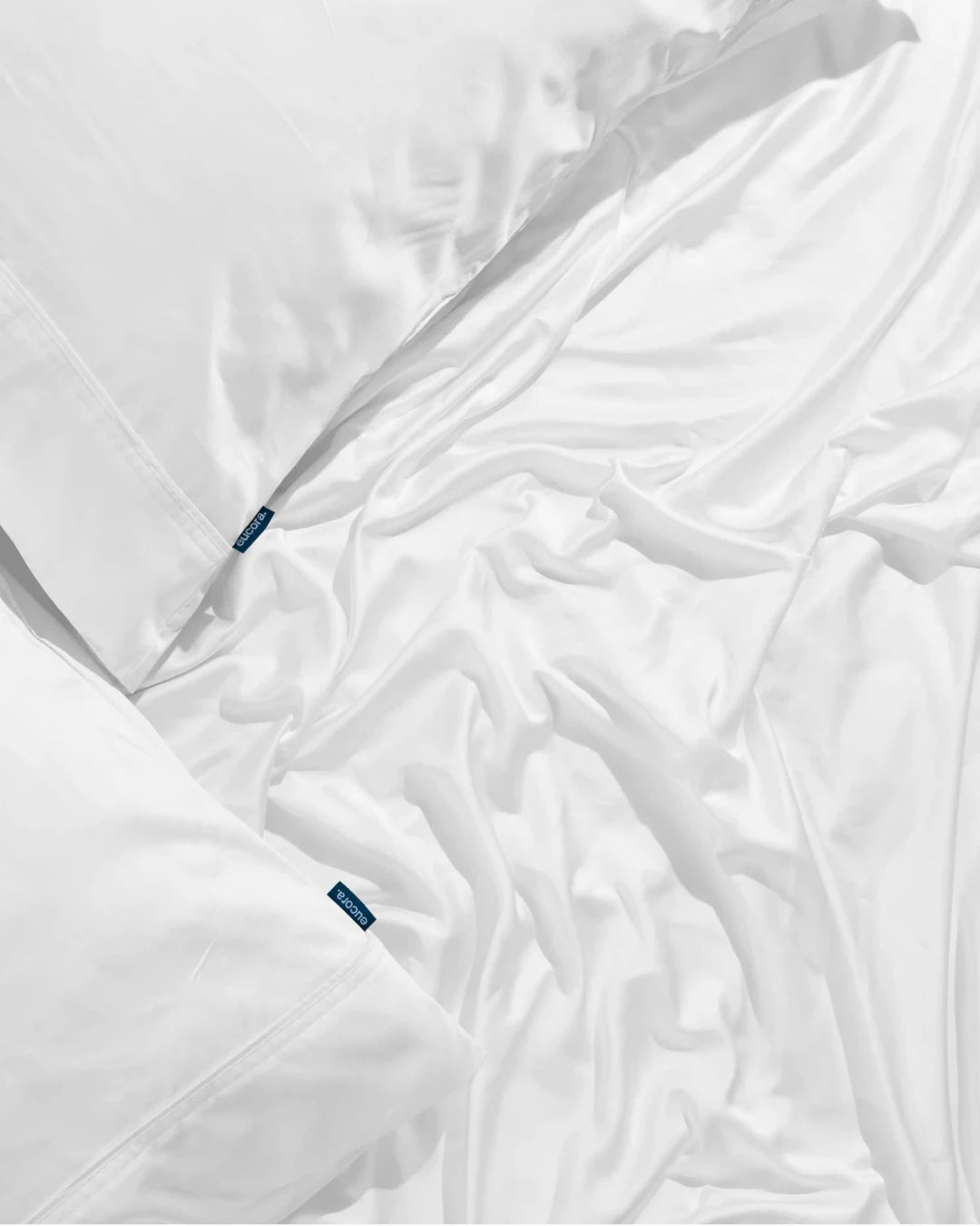 White comforter with brand labels on a white background