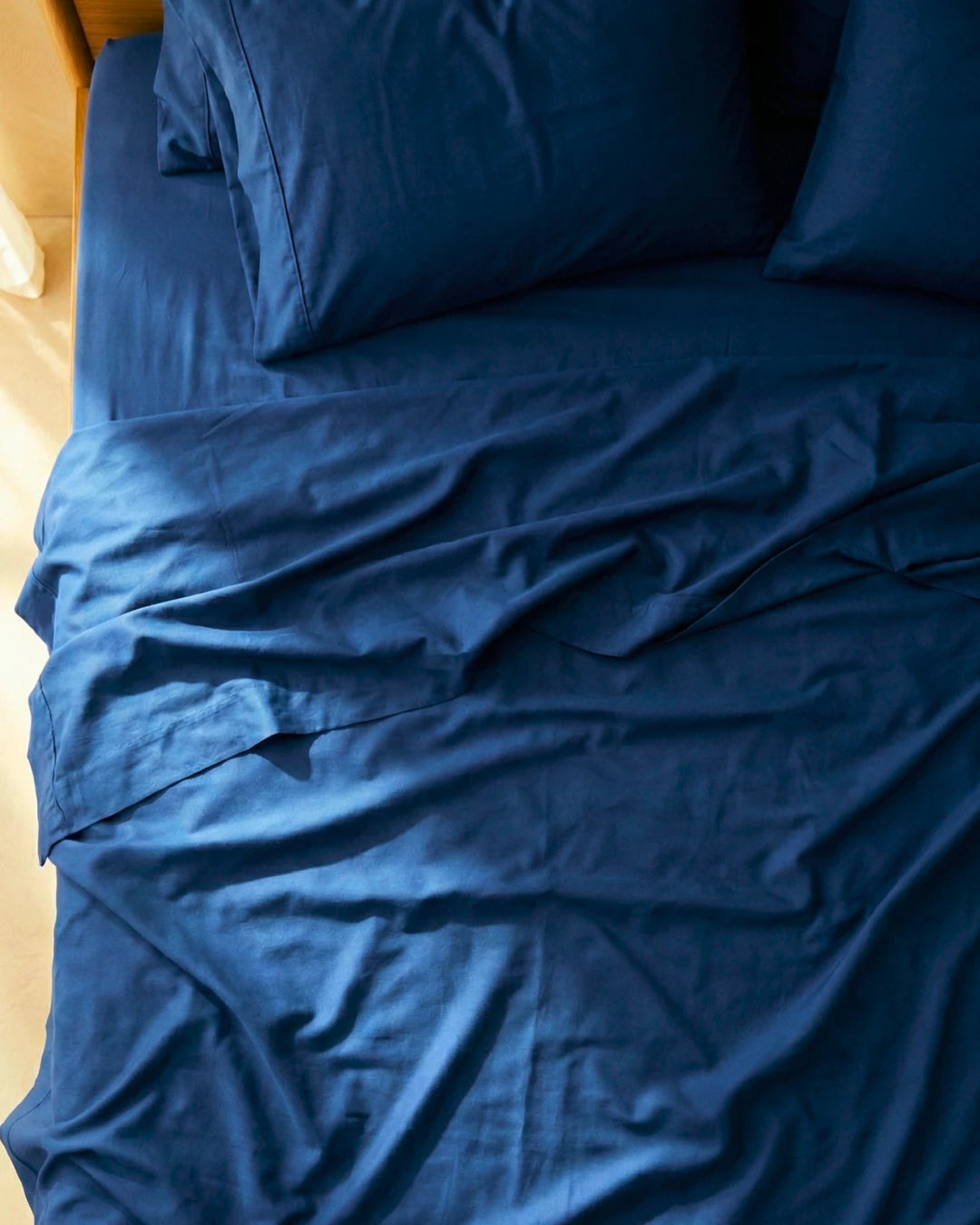 Blue bedding set on a bed with pillows