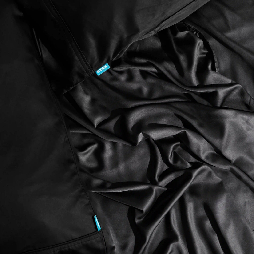 Close-up of black fabric with a brand label on a dark background