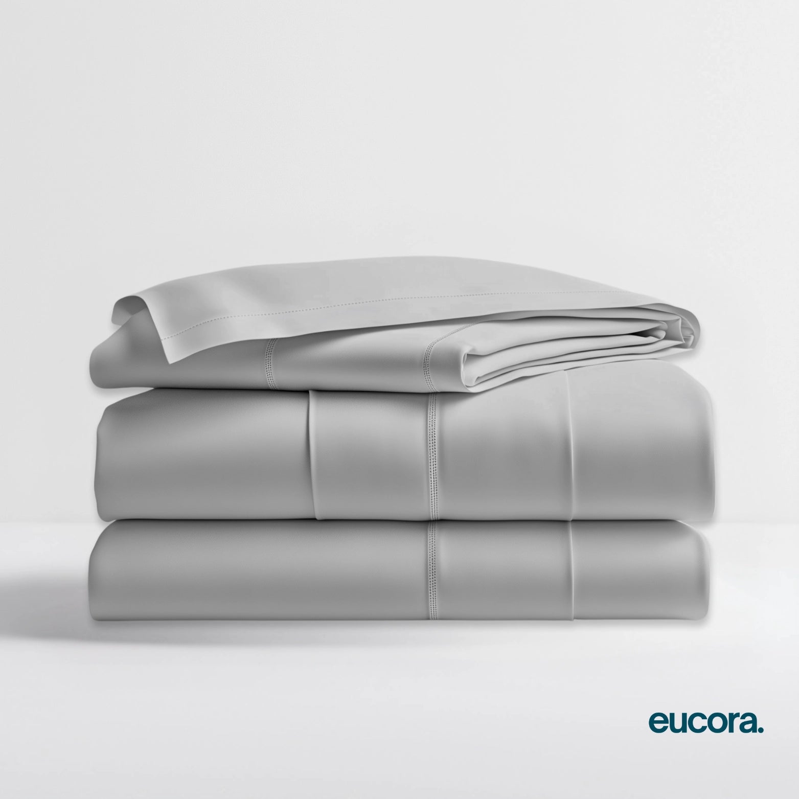 Light grey eucalyptus-infused bamboo bed sheets by Eucora stacked neatly to showcase premium softness, breathable texture, and luxury quality.