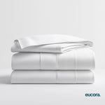 White eucalyptus-infused bamboo bed sheets by Eucora stacked neatly to showcase their crisp finish, silky softness, and clean, hotel-style luxury.
