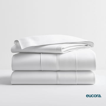 White eucalyptus-infused bamboo bed sheets by Eucora stacked neatly to showcase their crisp finish, silky softness, and clean, hotel-style luxury.